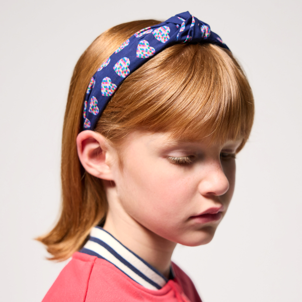 طوق شعر للفتيات وعليه عقدة.